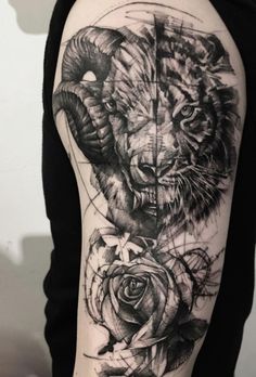 a black and white photo of a lion with roses on it's arm,