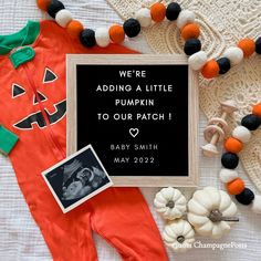 a baby's halloween themed photo frame and other decorations