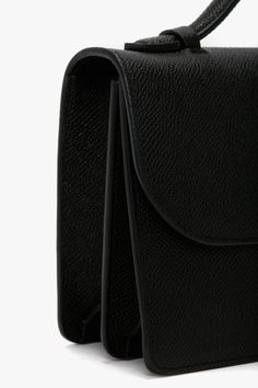 With its clean lines and slender silhouette, the Dorian Bag appeals to a multi-generational customer and is a hero item in the house’s leather goods edit. Crafted from tactile grained leather and designed in classic Black, it features the brand’s signature B buckle, which has been reworked to create a dynamic new locking system, and benefits from a removable and adjustable ‘smart strap’ and snap buttons for versatile styling as a shoulder or crossbody bag. Lined in microsuede, it has an internal Elegant Crossbody Bag With Grained Texture, Classic Top Handle Shoulder Bag With Grained Texture, Classic Shoulder Bag With Grained Texture And Top Handle, Luxury Grained Texture Top Handle Shoulder Bag, Classic Grained Texture Top Handle Shoulder Bag, Elegant Business Shoulder Bag With Grained Texture, Elegant Grained Texture Shoulder Bag For Business, Elegant Satchel With Grained Texture, Luxury Grained Texture Shoulder Bag For Business