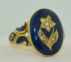 This ring is of the Victorian era, it is dated 1858. The ring is crafted from solid 18K yellow gold with a rich blue enamel. The enamel is in remarkably good condition on the shoulders as well as the face. The enamel surrounds a hand etched flower in yellow gold. The flower features 12 rose cut diamonds. The diamonds make up the composition of the flower. They are all bead prong set. The shoulders of this ring feature the same rich blue enamel. The inside is inscribed, I believe this was a memor Memorial Ring, Floral Ring, Silver Dragon, Dream Ring, Rose Cut Diamond, Sapphire Diamond, Pearl Ring, Victorian Era, Rose Cut