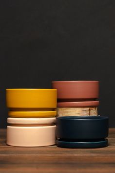 four different colored bowls stacked on top of each other