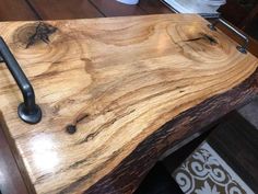 a close up of a wooden table with an iron handle on the top and bottom