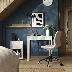 a white desk with a clock on the wall above it and a chair next to it