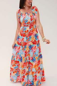 Look absolutely stunning on your next vacay with this From Coast to Coast maxi dress! It's eye-catching tropical print smocked ruffle tiered design is sure to make you the envy of the beach. Plus, with sizes S to XL, you can find the perfect fit for your coast-to-coast adventures! Wanna turn heads? Just add sand! **FS** Multicolor Summer Dresses With Palm Tree Print, Flowy Tiered Maxi Dress For Vacation, Tropical Floral Print Sundress For Vacation, Tropical Multicolor Sundress For Vacation, Beach Tiered Sundress With Smocked Back, Summer Tiered Maxi Dress For Beach Season, Hawaiian Style Sundress With Tropical Print For Vacation, Tropical Sundress For Beach Party, Tropical Sleeveless Dress With Smocked Back