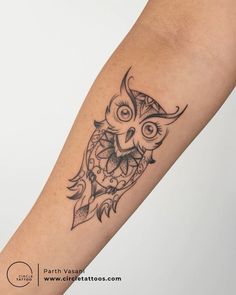 an owl tattoo is shown on the arm