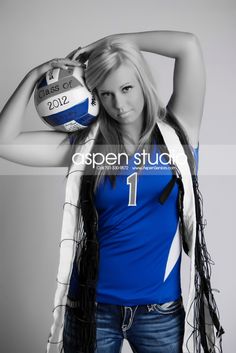 a beautiful young woman holding a volleyball ball