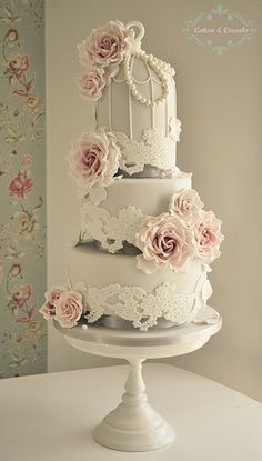 a white wedding cake with pink flowers on top