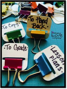 several different types of clothes clips with words to hand back and to grade written on them