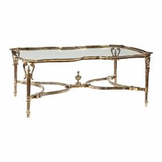 a gold coffee table with glass top and metal frame, in the style of art deco