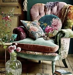 a chair with pillows and flowers on it