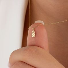 The tiny 14k solid gold pineapple necklace is a symbol of sweetness and joy. What can be sweeter than a pineapple? Whether you're gifting it to someone special or wearing it as a reminder of your own sweetness, this necklace is the perfect accessory to bring a touch of sunshine and happiness to your life. NECKLACE DETAILS * Material:14 carat solid gold * Weight: 0.91 grams (with 16 inch chain) * Dimensions: 5mm x 10mm * Chain: Cable * Style: Minimalist * Free Express Shipping Worldwide * 100% Ha October Jewelry, Tropical Necklace, Guardian Angel Necklace, Pineapple Jewelry, Hawaiian Necklace, Blue Sapphire Jewelry, Fruit Necklace, Pineapple Necklace, Gold Angel Wings