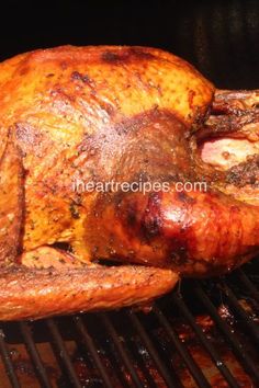 a roasted turkey is being cooked on the grill