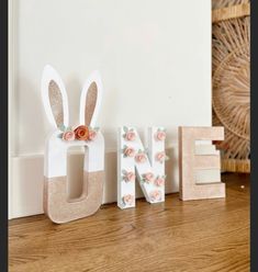 the letters are made out of wood and decorated with flowers