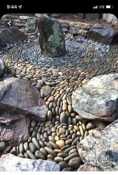 a rock garden with lots of rocks and stones around it, in the shape of a circle