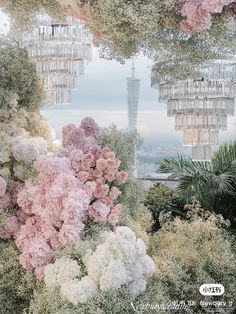 pink and white flowers are in the foreground with chandeliers hanging above them