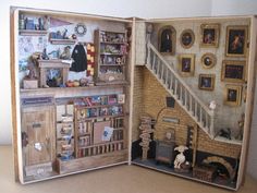 an open book with pictures on the wall and bookshelves in front of it