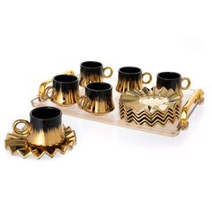 gold and black coffee set with matching cups