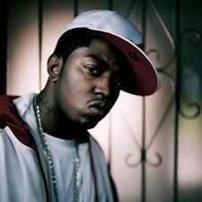 a young man wearing a red and white baseball cap standing in front of a wall