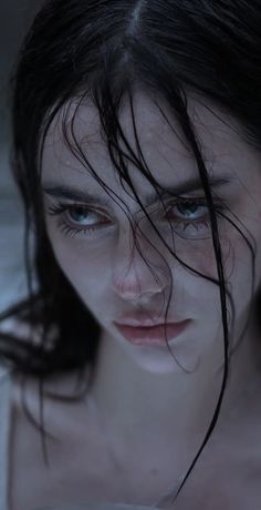 a woman with wet hair looking at the camera