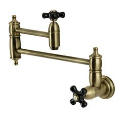 an antique brass faucet with two black handles