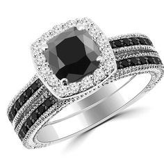 Product Description CR336 This unique vintage-inspired set includes a halo engagement ring and a matching wedding band. The main ring is made with a cushion-cut fancy black diamond. Both rings are accented with sparkling white and black diamonds. The rings are available in all precious metals. Product Details Center Stone: Fancy Black Diamond Center Stone Info: Cushion-Cut, 6mm, 1.40ct Total Diamond Weight: 2.15ct Accents: Black & White Diamonds Accents Info: VS-SI & 100% Opaque, 0.75ct Black Diamond Wedding Rings Sets, Black Diamond Halo Engagement Ring, Black Diamond Engagement Ring Halo, Halo Engagement Ring Set, Halo Engagement Ring Sets, Engagement Rings Cushion, Diamond Wedding Rings Sets