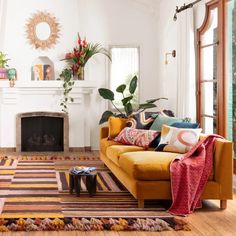 a living room filled with furniture and a fire place in the middle of a room