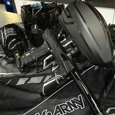 some hockey equipment is laying on top of a black jersey and helmet with the name army written on it