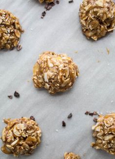 several cookies with nuts and chocolate chips on a sheet of parchment paper, ready to be eaten