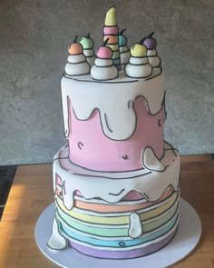 a multi - layered cake decorated with pastel colors and icing on a table