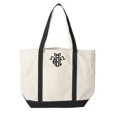 Add a touch of personality with our Monogrammed 'Bow' Canvas Boat Tote. This spacious tote features a unique monogrammed bow design, making it a stylish and personalized accessory for any outfit. Perfect for carrying all your essentials, this tote is both functional and fashionable. Measuring 21 1/2"w x 16"h x 6"d you can fit everything you need in here! 100% cotton 16 oz. contrast handles and gusset bottom outside pocket inside key ring holder inside valuables pocket Monogram Bow, United Monograms, Boat Tote, Key Ring Holder, S Monogram, Bow Design, Ring Holder, Key Rings, Key Ring