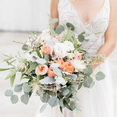 a bridal holding a bouquet of flowers and greenery