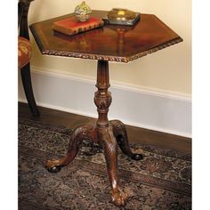 a table with a book on top of it in front of a chair and rug