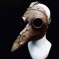 Plague Doctor Mask with a modern twist! This mask has an adjustable head buckle and an ornate beak. Ventilation rivet holes under the beak for easy breathing. Lightweight and comfortable to wear and tinted plastic acrylic lenses for viewing. Matching Plague hat sold separately! You can wear this Plague mask with Eye Glasses as well! The eye goggles of the mask are removable so you can wear it with your eyeglasses! Age Group/Gender - Adult/Unisex Size/Type - One size fits all adults Mask Color - Black/Brass Mask Material - Vegan Leather Accent Material - Paint Cloth Plague Doctor Mask, Gothic Steam Punk Masks, Black Plague Doctor Mask, Plaque Doctor, Black Plague Doctor, Doctor Bird, Mardi Gras Kid, Kids Party Packs, Facial Shapes