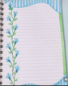 an open notebook with blue flowers on it