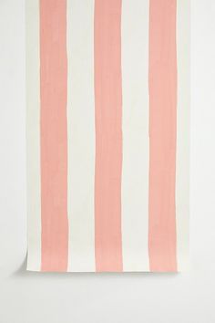 a piece of paper that has pink and white stripes on it, sitting on top of a table