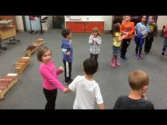 a group of children standing around each other in a room