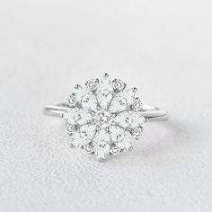 a diamond cluster ring on a white background