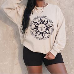 Sun Sweatshirt Celestial Crewneck Mystical Shirt Sun Moon Shirt Unisex Woman Oversized Indie Clothing Aesthetic Sweater Black Sunshine Moon Flowers Fall in love with this soft and cozy mystical Sun graphic tee or graphic Crewneck sweatshirt or Hoodie TO MAKE YOUR SHOPPING EXPERIENCE EASIER THIS LISTING GIVES THE OPTION TO CHOOSE A GRAPHIC T SHIRT, GRAPHIC SWEATSHIRT OR HOODIE Tee: Short sleeve 100% Cotton Crewneck Sizes: S-5X True to Size Sweatshirt/Hoodie Long Sleeve Crewneck Soft 50/50 blend S Long Sleeve Cotton Tops With Moon Print, Cotton Long Sleeve Tops With Moon Print, Long Sleeve Cotton Top With Moon Print, Aesthetic Long Sleeve Tops With Graphic Print, Aesthetic Long Sleeve Top With Graphic Print, Long Sleeve Graphic Print Aesthetic Top, Long Sleeve Tops With Graphic Print In Aesthetic Style, Oversized Cotton Top With Aesthetic Style, Bohemian Crew Neck Sweatshirt With Relaxed Fit