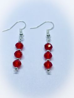 These are a lovely pair of Light Red Triple Crystal Faceted Crystal Dangle Dropper Earrings for pierced ears. They feature gorgeous 6mm briolette faceted crystal beads in a gorgeous light red colour. They are interspersed with silver colour metal round beads  These handmade earrings are on silver colour shepherds hooks and are suitable for people with pierced ears and are 1 inch in length with a drop of 1.75 inches. Please contact me if you would prefer these as clip ons.  I have a beautiful matching necklace which can be viewed by clicking this link: www.etsy.com/uk/listing/1395846155/dark-and-light-red-and-clear-crystal To view more JulieDeeleyJewellery handmade jewellery please click this link : www.etsy.com/shop/JulieDeeleyJewellery JULIE DEELEY JEWELLERY SOCIAL MEDIA LINKS Follow me o Red Drop Crystal Earrings As Gift, Red Drop Earrings For Pierced Ears, Red Teardrop Crystal Earrings, Red Crystal Drop Earrings For Pierced Ears, Red Drop Earrings For Gift, Red Crystal Drop Earrings For Gifts, Red Long Drop Earrings With Ear Wire, Red Hypoallergenic Drop Jewelry, Hypoallergenic Red Drop Jewelry