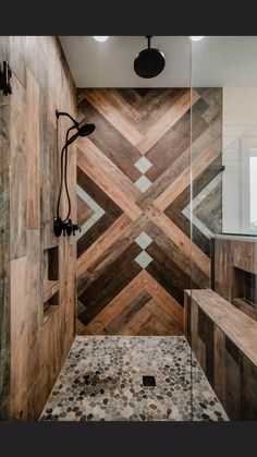 a walk in shower sitting next to a tiled wall and wooden flooring on the walls