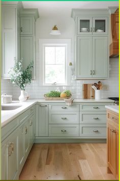 a kitchen with light green cabinets and white counter tops is featured in this postcard