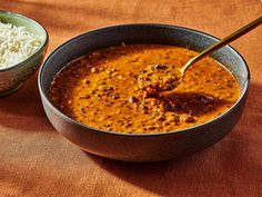 a bowl of chili and rice on a table