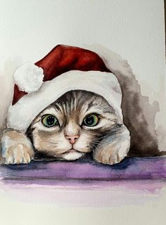 a watercolor painting of a cat wearing a santa hat on top of a table