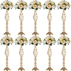 six golden candles with white and pink flowers on each candle holder, all in the same row