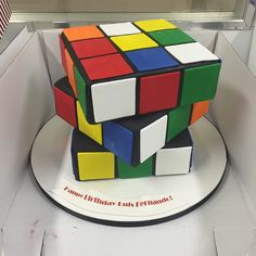 a cake made to look like a rubik cube is on display in a case