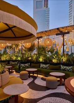 an outdoor seating area with tables and umbrellas