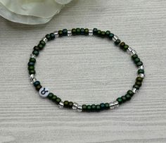 Select a bracelet length. This bracelet comes as stretch only (no clasp). Taurus birthdays: April 20th to May 20th Beads include: dark green and clear 6/0 seed beads (approximately 4mm) and one 7mm acrylic Taurus zodiac sign bead Bracelet is handmade and new. Please realize that the bracelet may vary slightly from the one pictured based on the different lengths and / or clasps chosen. Please see sizing details in shop FAQ.  Is this a gift? Don't know their bracelet length? The average bracelet length for teens is 6.5 inches.  The average bracelet length for women is 7.0 inches.  The average bracelet length for men is 7.5 inches. Follow my shop for discounts and promotions:  Instagram and Facebook @miasbeadmania Thank you for looking and supporting handmade shops on Etsy! All content © mias Seed Bead Bracelets For Men, Taurus Birthday, Taurus Zodiac Sign, Green Beaded Bracelets, Diy Jewlery, Zodiac Bracelet, Taurus Zodiac, Mens Beaded Bracelets, Seed Bead Bracelets