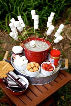 a bucket filled with marshmallows and other snacks