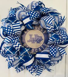 a blue and white wreath with the letter k on it