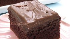 a piece of chocolate cake sitting on top of a white plate